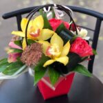 Bouquet of compliment of cymbidium and roses